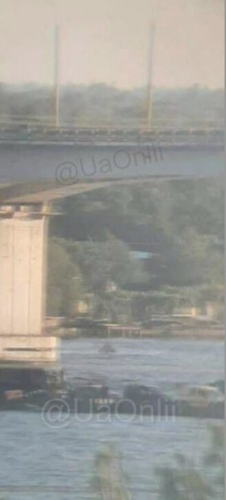 Russian forces have set up a ferry next to the destroyed E97 bridge in Kherson