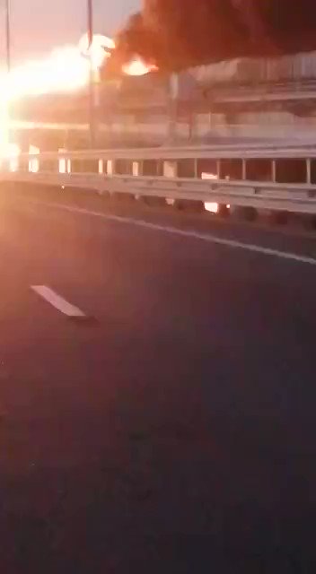 Footage taken from the road portion of the  Kerch Strait bridge shows at least two rail cars on fire